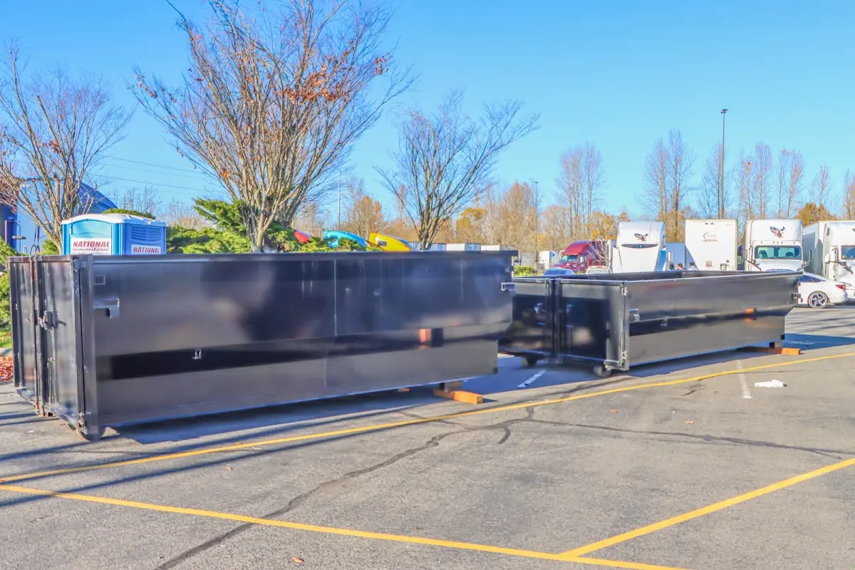 Professional dumpster rental service with roll-off container on residential driveway in Waynesville